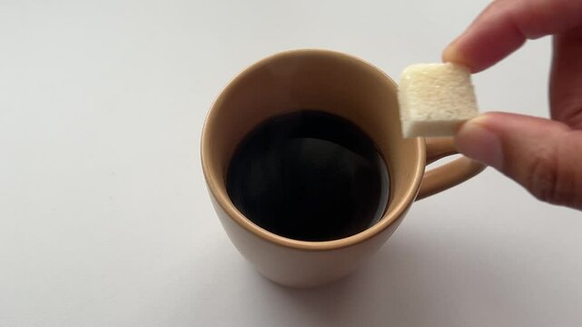 Putting a Sugar Cube in a Hot Cup of Coffee