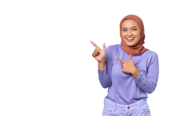 Portrait of smiling young Asian woman pointing finger at copy space isolated on transparent background