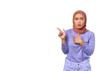 Portrait of shocked young Asian woman pointing finger at copy space isolated on transparent background