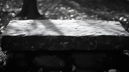 A solid stone bench in a peaceful outdoor setting, perfect for displays or peaceful scenes.