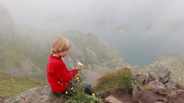 Children and adults, happy family with dog, climbing Festvagtinden via Heiavatnet trail in Norway