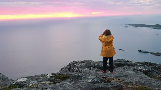 Children and adults, family with dog, hiking Grytetippen trail in Senja, Lofoten on a sunny summer day