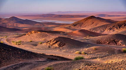 Fototapeta premium Vast desert landscape, varied colors, rolling hills.