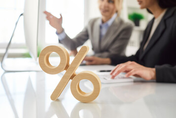 Per cent sign symbol on desk, calculate percentage, precise financial results, female client, boss...