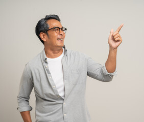 Naklejka premium Handsome asian mature old man standing on isolated white background. Happy Portrait of cheerful smiling senior asian man looking at camera. Mature People and lifestyle