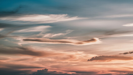 Dramatic sunset sky with varied clouds.