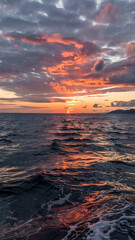Sunset over a rippling sea. Dramatic colors. Calm water.