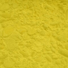 Bright yellow stone texture with scattered pebbles and organic shapes. Vibrant natural background ideal for modern design, textiles, product mockups, wallpapers, and creative projects.