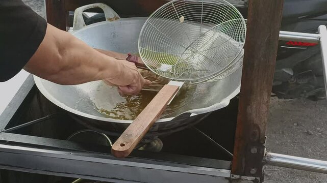 Indonesian Street Food Cilor Being Fried by Vendor&rsquo;s Hands