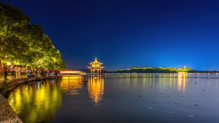 Captivating Night View of a Tranquil Lake with Golden Reflections