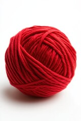 Bright red yarn ball ready for knitting or crocheting projects on a plain background