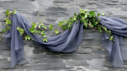 Sheer fabric flows gracefully intertwined with ivy, draping against a rugged stone wall, highlighting an atmosphere of timeless elegance and natural beauty