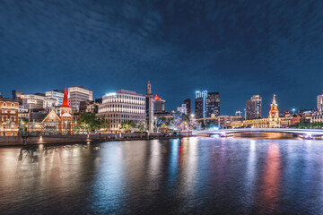 Fototapeta premium Captivating Nightscape of Melbourne's Skyline Reflected in Tranquil Waters