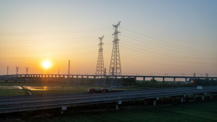 Breathtaking Sunset Over Power Lines: A Tranquil Evening Landscape