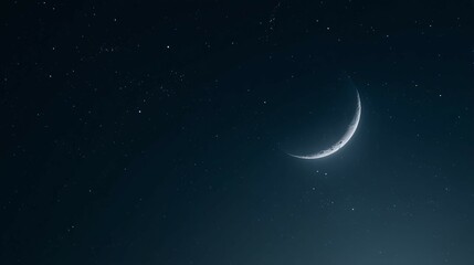 Fototapeta premium Crescent moon shines brightly in a dark night sky with scattered stars.