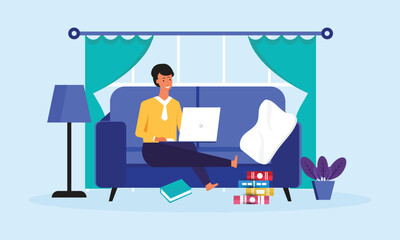 Smiling Man with a laptop working or studying at home sitting on a sofa in the living room
