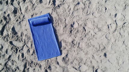 Blue Beach Towel on Sandy Beach