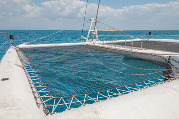 Catamaran netting is taut, providing a clear view of the mesmerizing blue water below