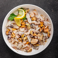 Seafood mix frut de mer mussels, shrimp, prawn, rapan, squid dish fresh gourmet food background on the table rustic food top view copy space keto  paleo diet vegetarian pescetarian diet