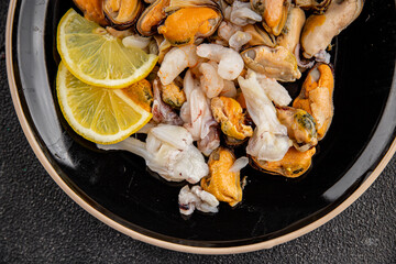 Seafood mix frut de mer mussels, shrimp, prawn, rapan, squid dish fresh gourmet food background on the table rustic food top view copy space keto  paleo diet vegetarian pescetarian diet