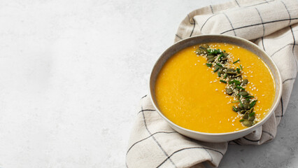 Creamy butternut squash soup with pumpkin seeds and sesame. Copy space