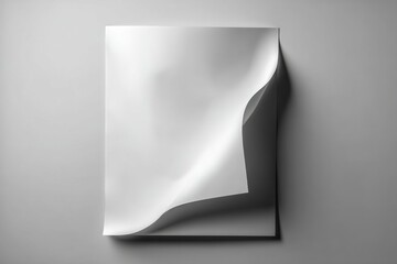 A blank white sheet of paper with a curled corner casting shadows on a grey backdrop, offering a clean surface for design and text placement, inviting creativity.