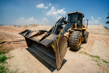 A Sand Moving Excavators: Two Excavators and Bulldozers Close-Up, Construction Equipment for Earthwork, Yellow Loader with Big Bucket on Construction, Construction Equipment