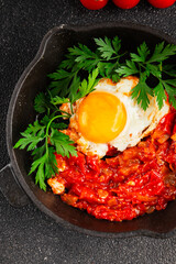 Fried egg tomatoes shakshuka vegetable dish appetizer fresh delicious gourmet food background on the table rustic food top view copy space vegetarian  food