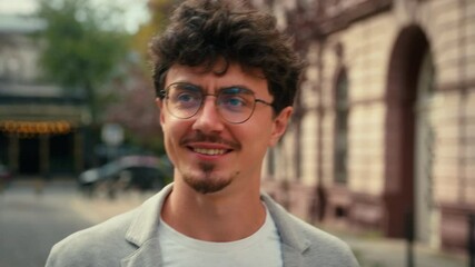 Walking in city smiling happy business man wearing glasses successful confident cheerful ethnic Hispanic businessman walk go outside outdoors smile male guy traveler moving going at street sunny day