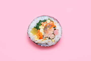 Roll of Korean kimbap on pink background, top view.
