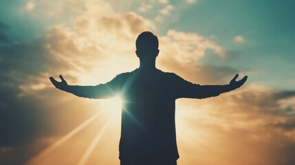 Fototapeta premium A person stands with arms wide open against a stunning sunset, expressing joy and appreciation as rays of light pierce through clouds