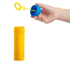 Plastic yellow bottle of soap bubbles in hand isolated on white background