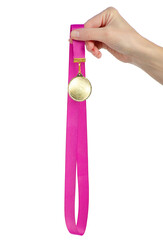 Gold medal on ribbon in hand on white background isolation