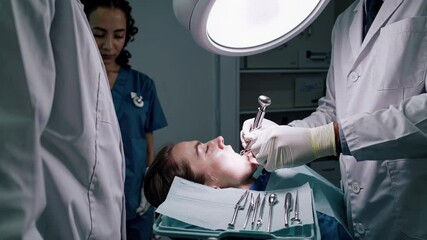 Skilled dentist performing detailed dental procedure, carefully drilling and treating patient's teeth using professional medical equipment in modern clinical setting