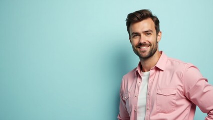 Fototapeta premium Zego. Smiling man with beard wearing pink shirt posing against blue wa