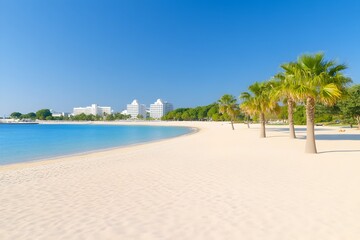 Serene coastal scene; pristine white sand beach curves gently into turquoise water,  palm trees line the shore under a clear blue sky, buildings in the distance