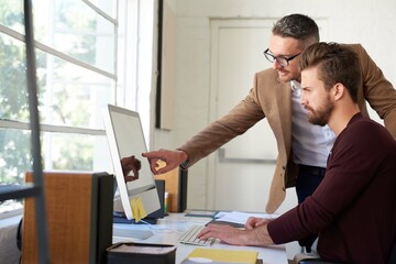 Business, men and creative on computer in office for research, planning and ideas as web designer...