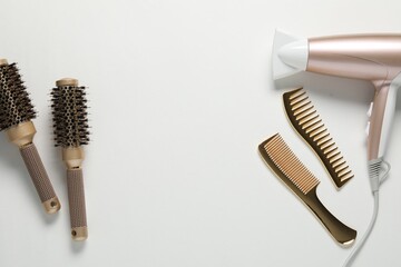 Different hairstyling tools on white background, flat lay. Space for text