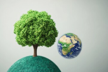 Green Tree on Hill with Earth Globe on Neutral Background