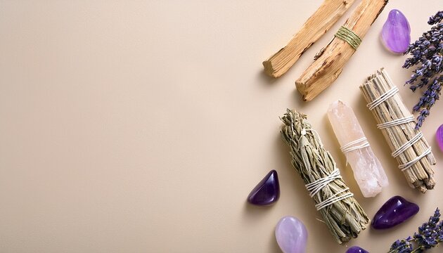 white sage and palo santo and amethyst and quartz crystals on a light beige background
