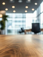 Office interior with wood table in foreground and soft focus background with chairs and windows