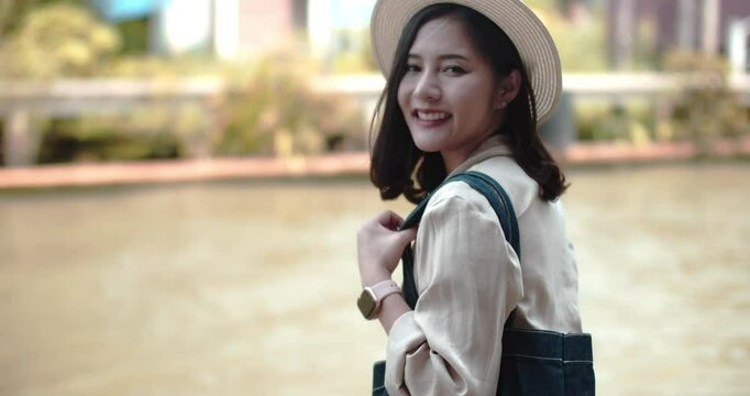 Asian tourist woman taking picture and smile and travel along the canel Damnoen Saduak Floating Market ratchaburi,Thailand