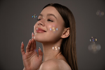 Young Woman Surrounded by Soap Bubbles in Gentle Portrait