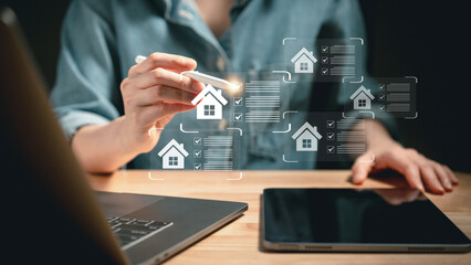 Close-up of individual using stylus to interact with virtual housing checklists on screen...