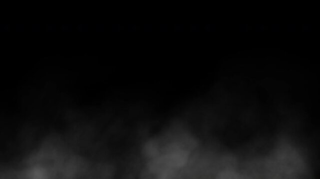 White fog hovering above the ground on a black background. Seamless animation.
