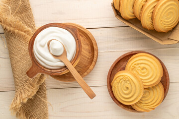 Shortbread sweet cookies with kitchen utensils on a wooden table, close-up, top view.