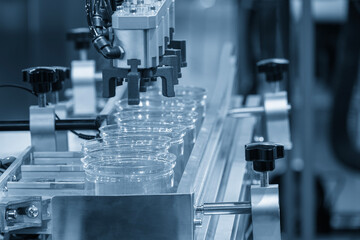 The high technology material handling process from injection machine by robotic system.