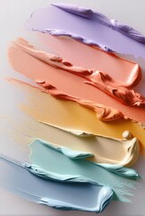 Colorful paint strokes in purple, orange, yellow, and blue on a light background, showcasing texture and abstract art. Ideal for creative design and artistic inspiration.