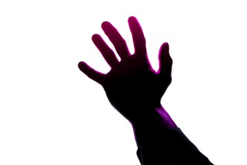 Silhouette of a hand reaching out against a bright background