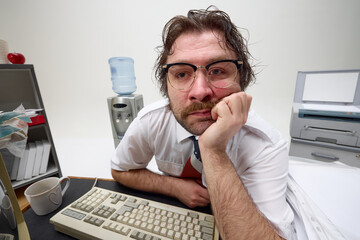 Frustrated office worker leans on desk, looks tired, surrounded by retro tech and paperwork,...